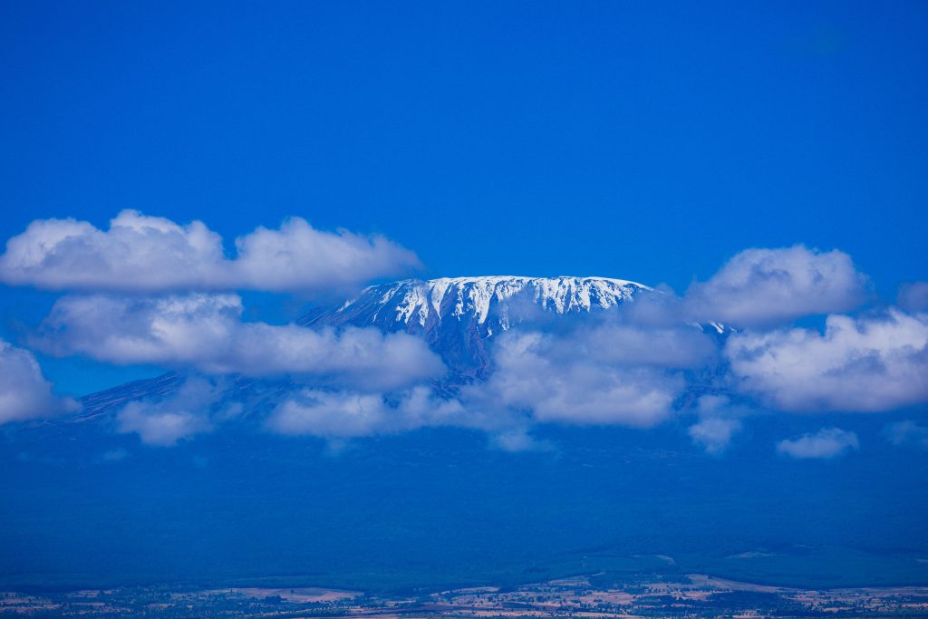 Mount Kilimanjaro is a dormant volcano located in Kilimanjaro Region of Tanzania. It has three volcanic cones: Kibo, Mawenzi, and Shira. It is the highest mountain in Africa and the highest single free-standing mountain above sea level in the world: 5,895 m above sea level and about 4,900 m above its plateau base.