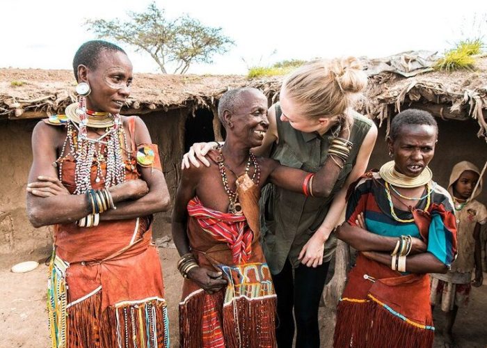 Family participating in cultural activities with Maasai community in Tanzania