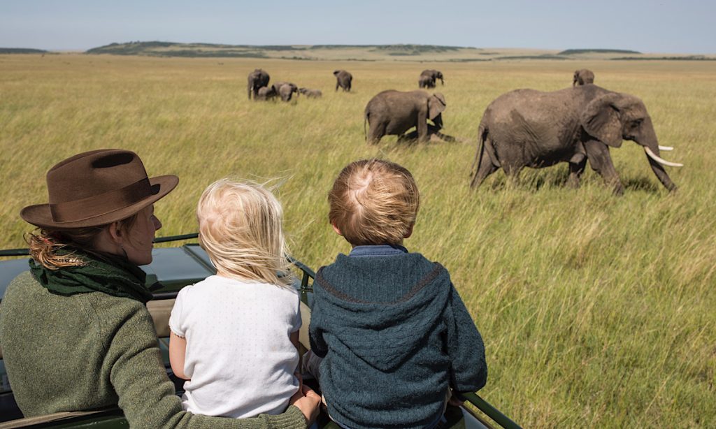 Family enjoying breakfast at a safari lodge in Tanzania