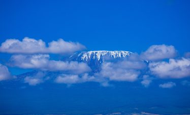 Mount Kilimanjaro is a dormant volcano located in Kilimanjaro Region of Tanzania. It has three volcanic cones: Kibo, Mawenzi, and Shira. It is the highest mountain in Africa and the highest single free-standing mountain above sea level in the world: 5,895 m above sea level and about 4,900 m above its plateau base.