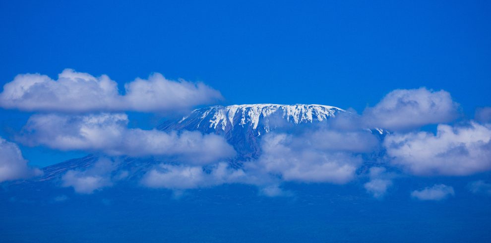 Mount Kilimanjaro is a dormant volcano located in Kilimanjaro Region of Tanzania. It has three volcanic cones: Kibo, Mawenzi, and Shira. It is the highest mountain in Africa and the highest single free-standing mountain above sea level in the world: 5,895 m above sea level and about 4,900 m above its plateau base.