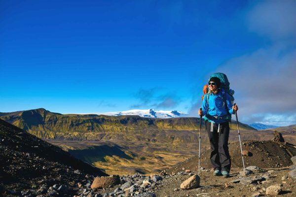 woman hiker on the trail in the Islandic mountains. woman standing and posing against the backdrop of a desert mountain landscape. Treking in National Park Landmannalaugar, Iceland. Travel photography concept